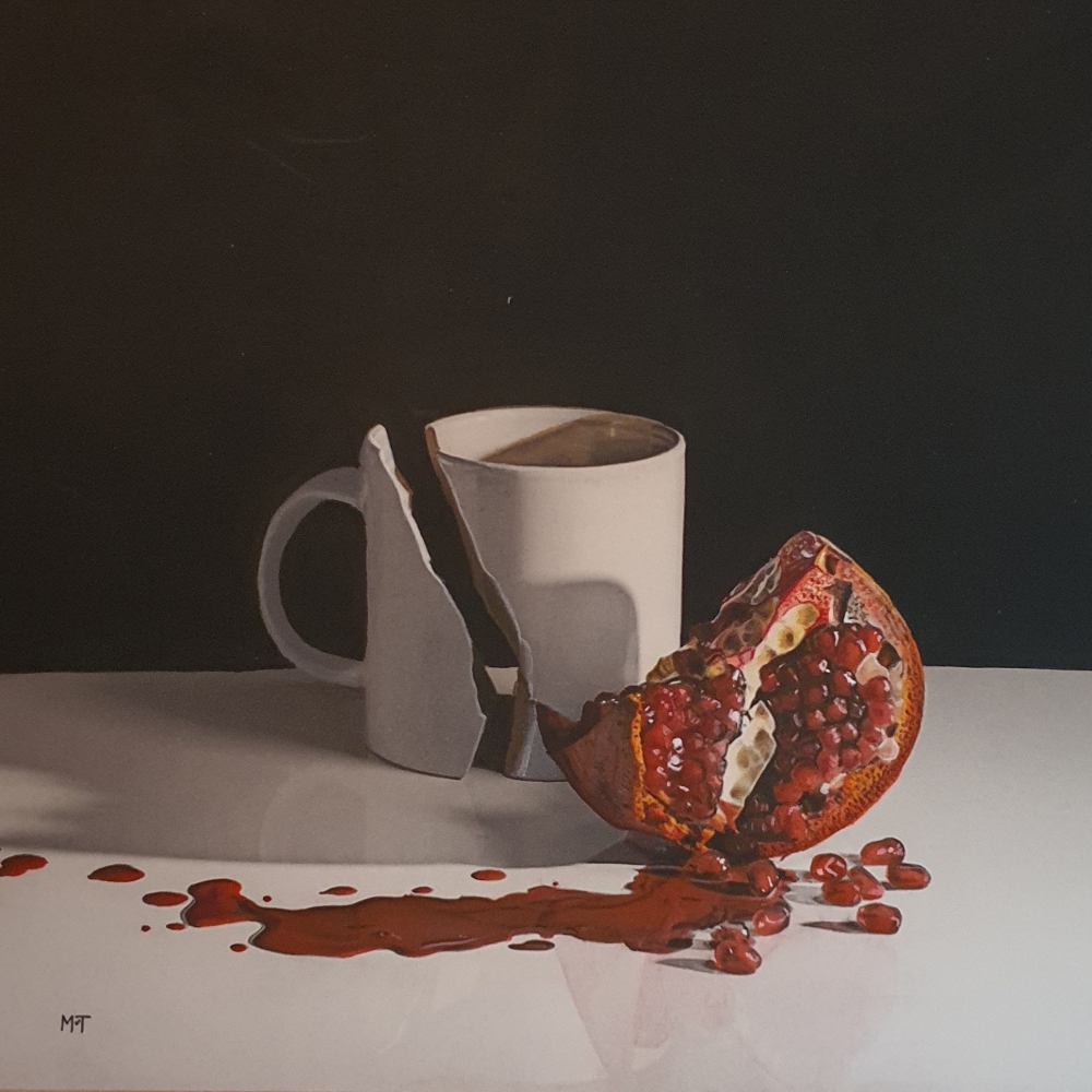 Broken mug with pomegranate